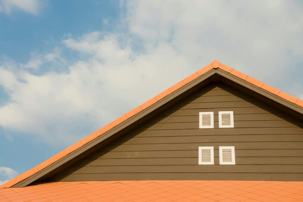 Orange and gray painted roof and siding in Dallas, TX